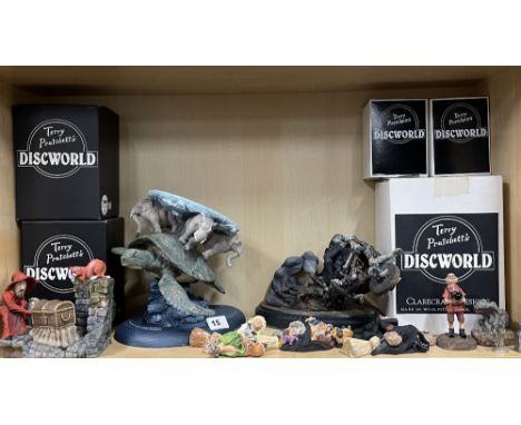 A collection of Terry Pratchett Discworld Clarecraft figures including, DW41-Rincewind luggage and cat bookend, DW70-Limited 