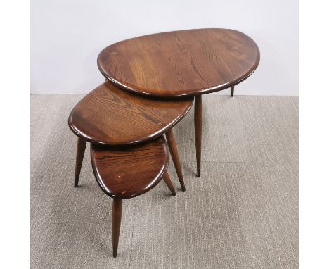 A nest of three mid century Ercol stained elm 'Pebble' tables on splayed legs, largest 65 x 45 x 40cm.