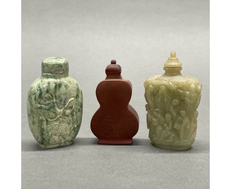 Two Chinese carved jade/hardstone snuff bottles and a Yixing snuff bottle, tallest 8cm.