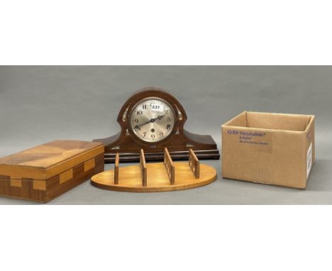 An inlaid mahogany veneered mantel clock, W. 45cm. Together with a wooden writing slope and a collection of eggs with wall ra