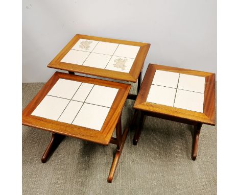 A nest of three tile topped teak side tables, largest 58 x 48 x 43cm.