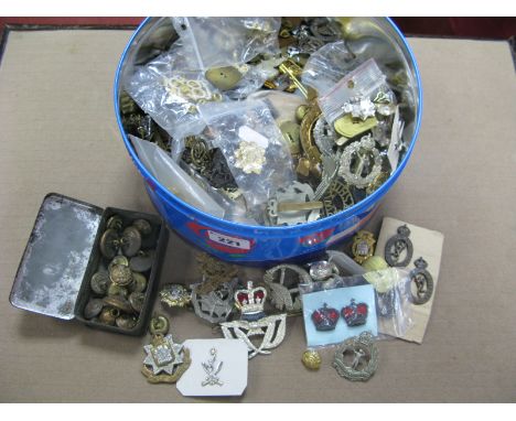 A Tin of Predominately Post War British Military Cap Badges and Shoulder Ties, Buttons, many regiments represented including 