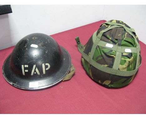 A WWII Era Tommy Helmet, marked 'FAP', plus a 2nd half XX Century British helmet.