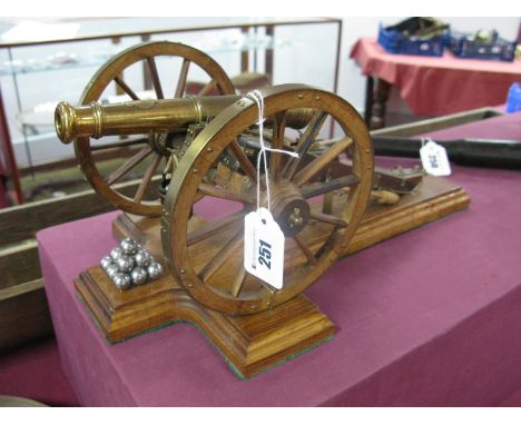 A Scale Model of British Waterloo Period Nine Pounder Artillery Cannon, brass and wood construction, barrel length 20cm, whee