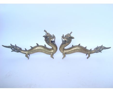 A pair of Chinese polished bronze dragons, 17cm high (2). 