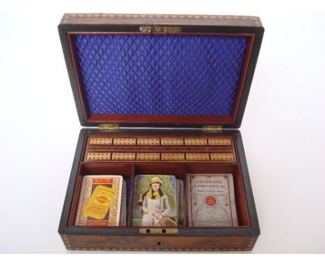 A Victorian burr walnut and parquetry banded games box, the hinged lid lined with blue silk opening to reveal a fitted interi