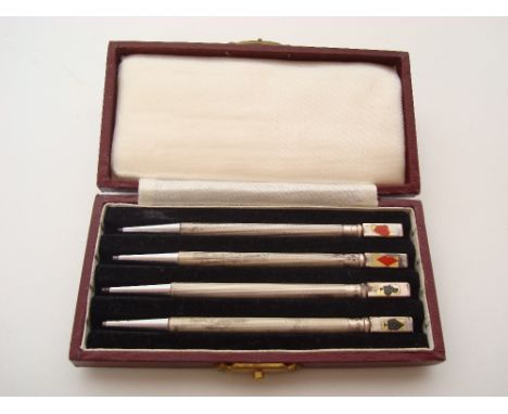 A set of four sterling silver bridge pens, engine turned, in fitted case. 