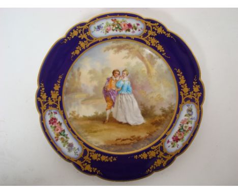 A late 19th Century Sevres cabinet plate, the centre painted in enamel with a courting couple in a landscape after Boucher wi