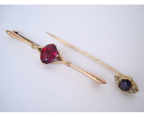 A late Victorian sapphire and diamond set stick pin, unmarked together with an almandine garnet set 9 carat bar brooch. 