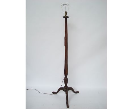A George III mahogany torchere adapted as a standard lamp, the fluted baluster stem on leaf carved cabriole tripod supports. 