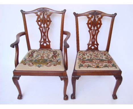 A set of eight George III style dining chairs of Chippendale design, each with serpentine crest rails with leaf carved ears, 