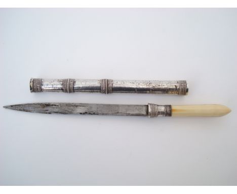 A 19th Century Burmese Dha dagger, the steel blade 18.5cm long with ivory hilt and white metal sheath, 30cm long. 