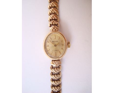 Ladies 9ct gold Accurist wristwatch, with oval dial with baton markers and manual wind 21 jewel movements, on 9 ct gold brace