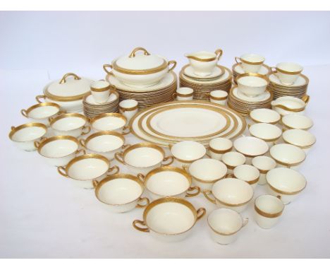 A Royal Doulton H2908 twelve setting dinner, tea and coffee service, cream ground with gilt tooled borders comprising eleven 
