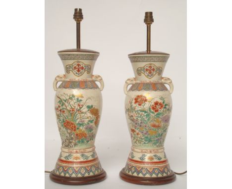 A pair of 19th Century Japanese satsuma vases, each with twin mask handles, the bodies painted in enamel colours with crysant