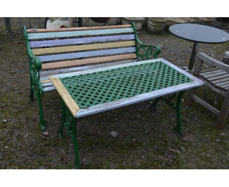 A PAINTED CAST IRON GARDEN BENCH with wooden slats, width 129cm together with a matching lattice topped coffee table (2)