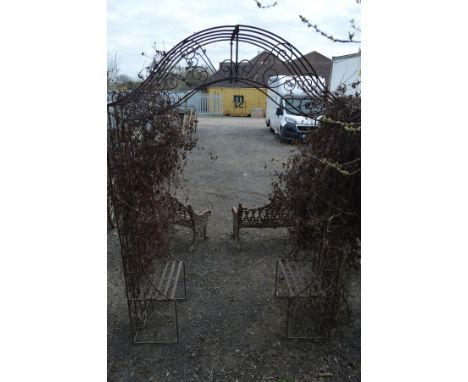A WROUGHT IRON GARDEN ARCH with scrolled decoration and seating, width 181 x height 258cm 