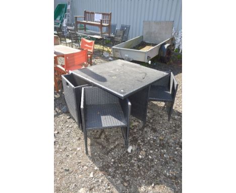 A CUBED RATTAN GARDEN TABLE with a glass insert top, 111cm squared x height 71cm and four matching armchairs (5)