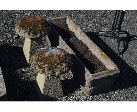 A RECTANGULAR COMPOSITE GARDEN PLANTER, width 102cm x depth 32cm together with a pair of composite staddle stones with tops (
