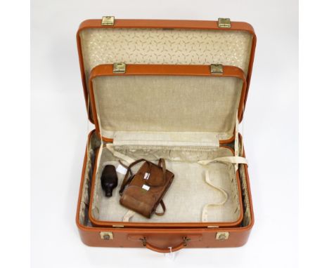 Two tan brown leather suitcases, a leather cased camera, together with a hip flask