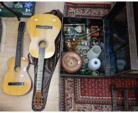 A tin trunk containing glassware, etc, with two guitars (3) 