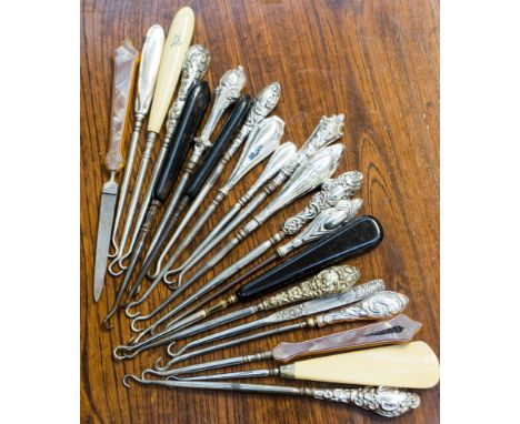 Twenty one various silver hafted ebony, etc, handled button hooks 