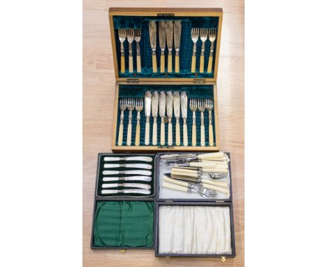 A boxed set of mother of pearl tea knives, boxed fish eaters and a small canteen of cutlery, with silver ferrules, Sheffield 