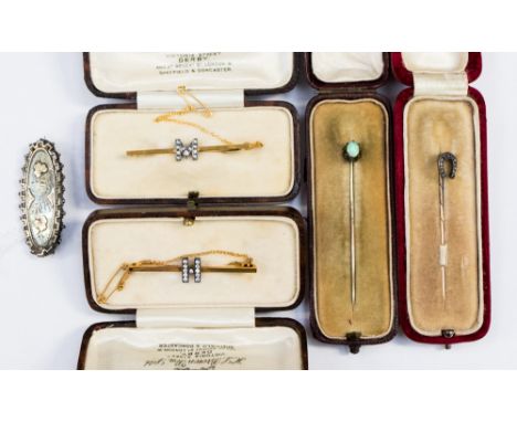 A 9ct yellow gold bar brooch, with paste set white metal M to centre and another with paste white metal set it to centre, app