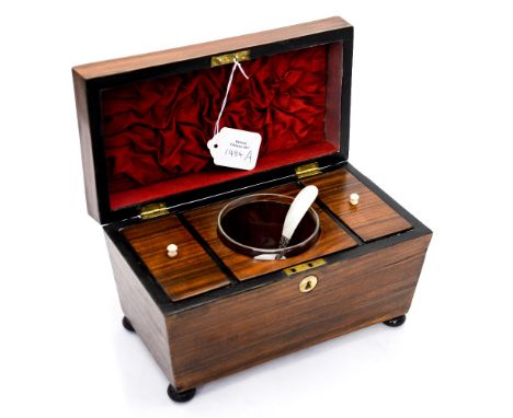 A 19th Century sarcophagus shaped tea caddy, fitted interior, raised on four ball feet 