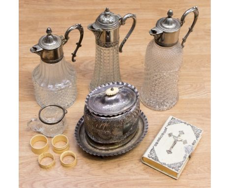Three silver plated topped decanters, a silver plated tea caddy on stand, ivorine bible, napkin rings and jug (one box)