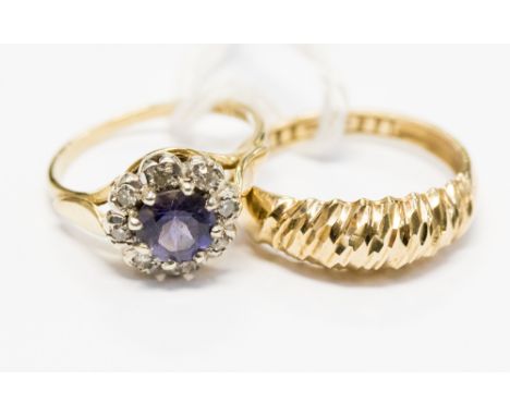 A blue stone and diamond chip 9ct yellow gold cluster ring, the blue stone tanzanite or Iolite, ring size K½, total gross wei