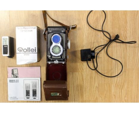 A German Rolleiflex camera Franke & Heidecke, synchro comparison lense, leather case, together with lenses, flash instruction