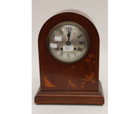 An Edwardian mahogany eight day mantle clock, with a silvered dial, foliage marquetry inlaid case 
