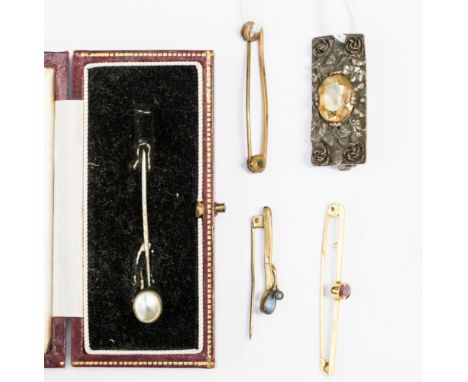 A 9ct gold garnet set bar brooch approx 1.8 gms, together with a silver stick pin and three other brooches 