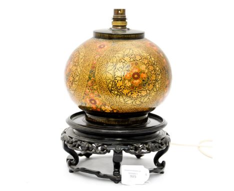 A Kashmir papier - mache table lamp, of globular form, richly decorated in coloured enamels and gilding with roundel's, on a 