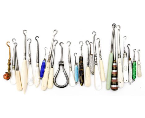 Twenty four various ivory, bone and enamelled hafted button hooks 