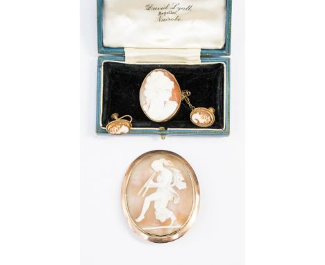 A 19th Century shell cameo brooch depicting a scantily clad classical maiden, in a yellow metal surround, together with anoth