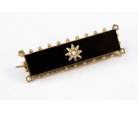A Victorian seed pearl and onyx 9ct yellow gold mourning brooch with glazed compartment to reverse, approx 46 mm, gross weigh