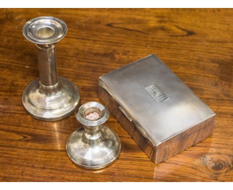 A silver cedar lined cigarette box, Birmingham 1953, with two silver candle holders, one rubbed hallmark, one Birmingham 1924