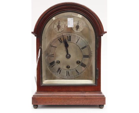 A mahogany mantle clock, silvered dial, Roman numerals, pendulum and key 