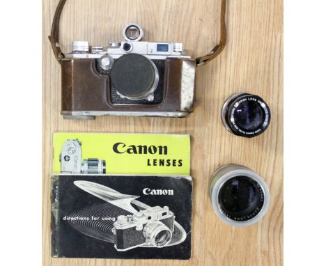 A Canon camera No 211647, leather cased with cased lenses, instructions etc (1 bag)