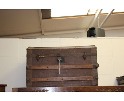 A late 19th/early 20th Century travelling trunk, canvas body, Beech strapped and iron bound 