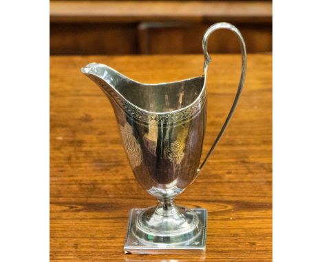 A George V silver Neoclassical helmet shaped cream jug, laurel leaf and scroll decoration makers mark SM, London 1912, height