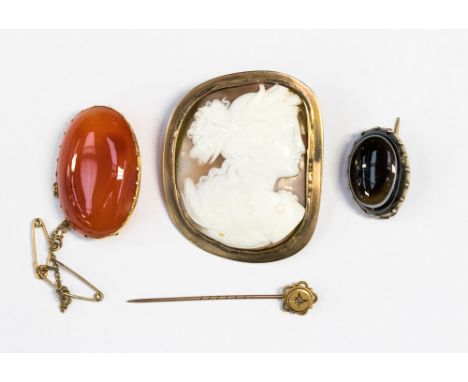 A tested gold framed carved cameo, a gold framed carnelian a gold framed banded agate brooch and a stick pin with small diamo