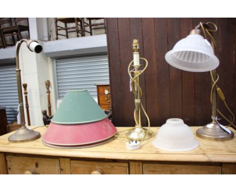 Three brass table lamps; along with a brass standard lamp with shades 