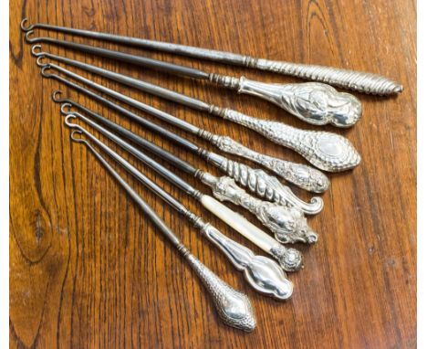 Nine silver hafted and mother of pearl hafted button hooks 