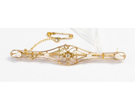 A diamond and pearl set yellow metal brooch, the centre old cut diamond in flower setting with two pearls either side, openwo