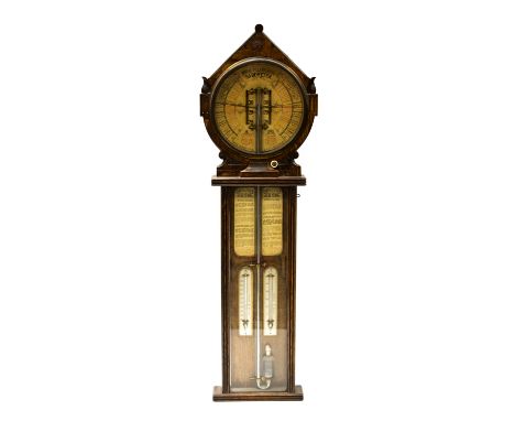 A carved oak Royal Polytechnic Barometer Joseph Davis & Co, London, circa 1885. With foliate carved gabled pediment above 9.5