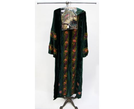 A 1960 embroidered velvet button through long (full length) coat; together with a velvet embroidered 1960s cap (2) 