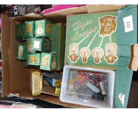 A box of vintage light bulbs plus some NGK spark plugs and Champion spark plugs.